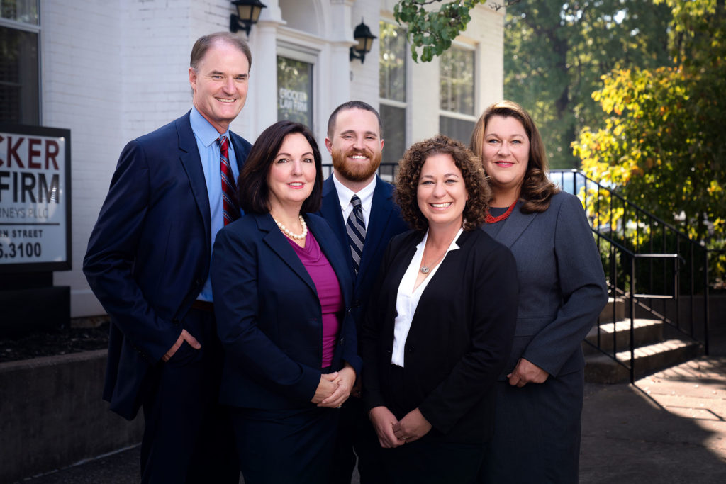Crocker Law Firm's attorney team with Ben Crocker, Cyndi Crocker, Joseph McReynolds, Angela Kniery, and Robin Hewitt, are standing in front of the Crocker Law Firm Personal Injury Attorneys building in Bowling Green, Kentucky