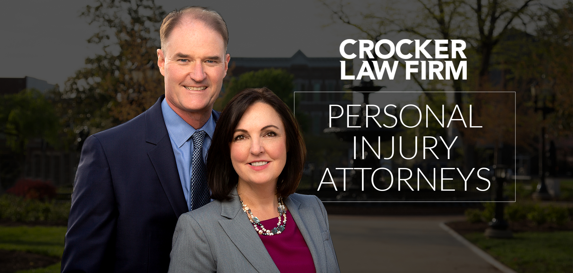 Ben and Cyndi Crocker Partner Attorneys at Crocker Law Firm Personal Injury Attorneys smile at fountain square park with 'Personal Injury Attorneys' text