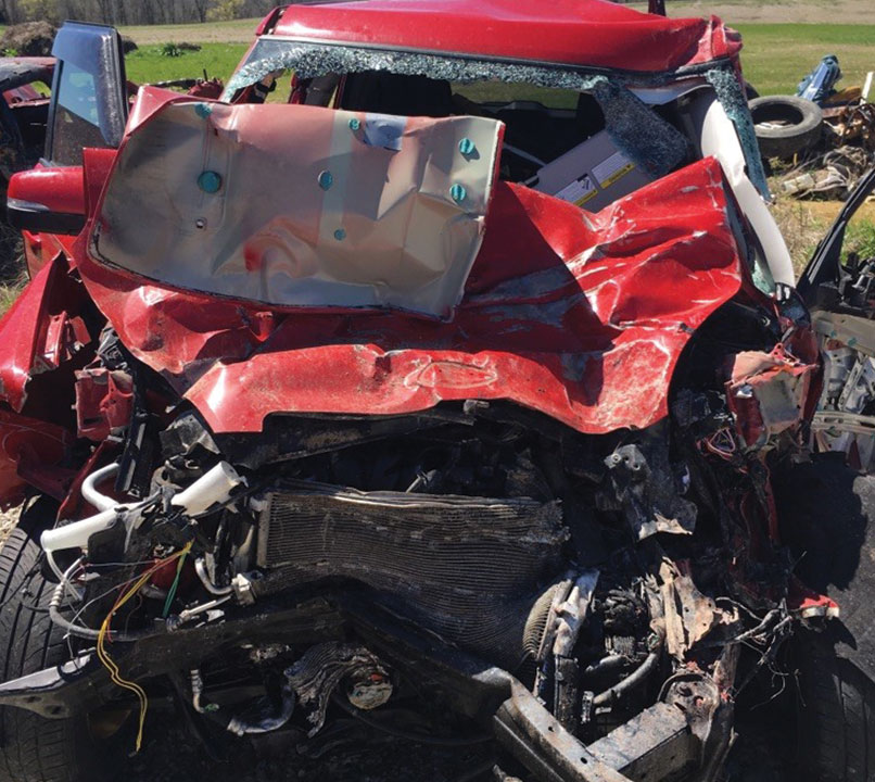 Beth Waddell's wrecked red Kia Soul at junkyard in Bowling Green, Kentucky