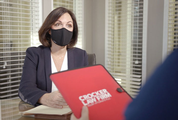 Cyndi Crocker Car Accident Lawyer meeting with a client wearing a mask for COVID-19 safety in a conference room