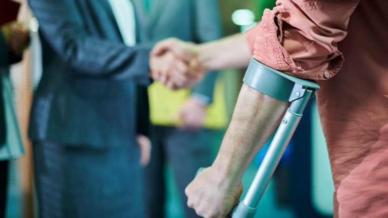 Injured man shakes hands with man wearing suit for Crocker Law Firm blog post