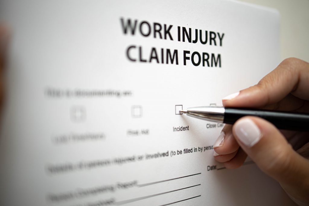 Persomn Filling a Work Injury Claim Form